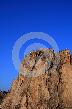 SHEER CLIFF ILLUMINATED BY THE SUN