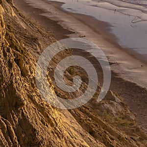 Sheer cliff secluding the shore of Blacks Beach photo