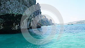 Sheer cliffs, blue water and a Viking cave. Phi Phi Islands, Thailand.