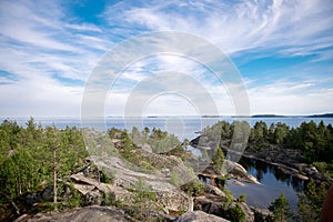 Sheer cliffs on Ladoga skerries. Granite island of Sortavaly in summer under a blue sky photo