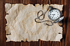 Sheet of ancient parchment and pocket watch