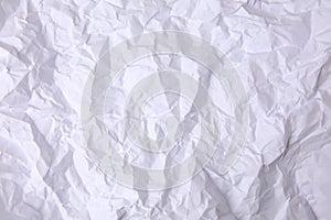 Sheet of crumpled paper white as background, top view