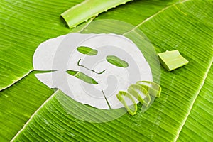 Sheet Mask with aloe on a background of banana leaf. Organic cosmetics concept