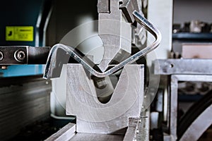 Sheet metal bending on a hydraulic bending machine. Metal part after bending