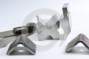 Sheet metal bending tool and equipment isolated on a white. Bend tools, press brake punch and die. Digital protractor