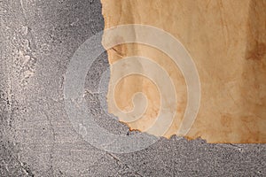 Sheet of old parchment paper on gray textured table, top view. Space for text