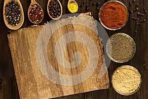 Sheet old vintage paper with spices on wooden background. Healthy vegetarian food.