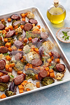 Sheet pan dinner with sausage and vegetables roasted and ready to eat