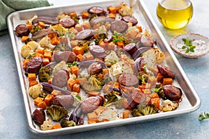 Sheet pan dinner with sausage and vegetables roasted and ready to eat