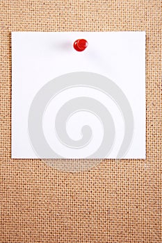 A sheet of paper attached by a thumbtack