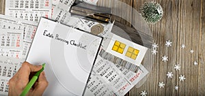 Sheet of paper -Estate Planning Checklist and small paper house with coins on the New Year& x27;s background