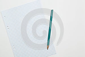 a sheet of paper for notes and a green pencil, white background