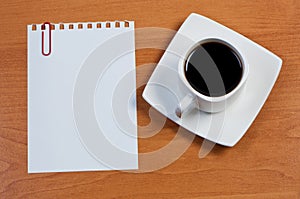 Sheet paper with paperclip and cup coffee.