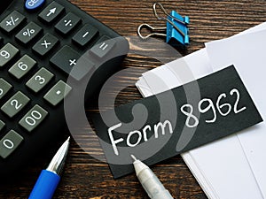 Sheet with words Form 8962 irs and calculator.
