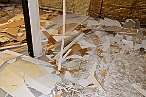 Sheetrock strewn on floor in a demolition project photo