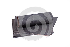 Sheets of black sandpapers on a white background
