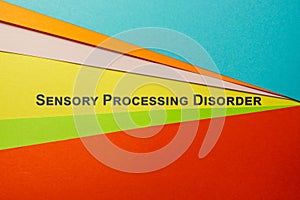Sheets of colored paper and sign Sensory Processing Disorder SPD.