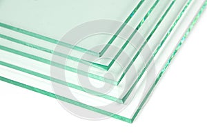 Sheets of Factory manufacturing tempered clear float glass panels cut to size. White background