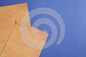 Sheets of old parchment paper on blue background, flat lay. Space for text