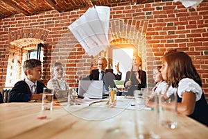 Sheets of paper flying in the air , business team rejoicing at success