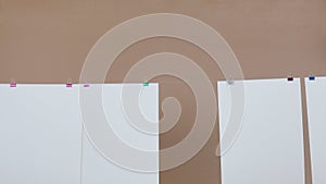 Sheets of paper hanging from a thread