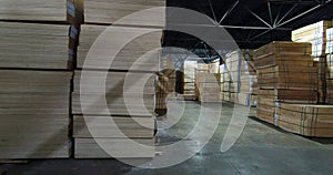 Sheets of plywood slabs are stacked in the warehouse of the woodworking plant