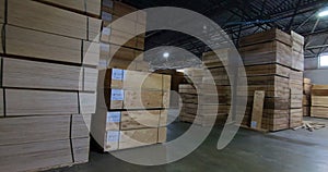 Sheets of plywood slabs are stacked in the warehouse of the woodworking plant