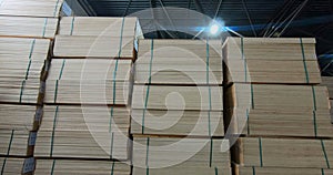 Sheets of plywood slabs are stacked in the warehouse of the woodworking plant