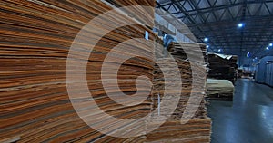 Sheets of plywood slabs are stacked in the warehouse of the woodworking plant