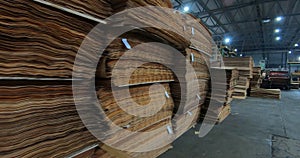 Sheets of plywood slabs are stacked in the warehouse of the woodworking plant