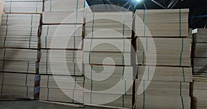 Sheets of plywood slabs are stacked in the warehouse of the woodworking plant