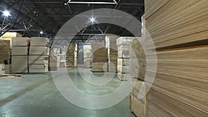 Sheets of plywood slabs are stacked in the warehouse of the woodworking plant