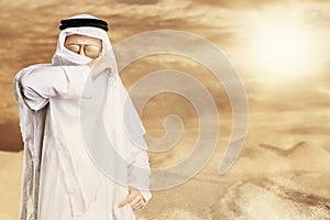 sheik protect with keffiyeh from desert storm in front of sunlight
