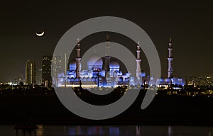 Sheik Zayed Mosque as seen at night with moon