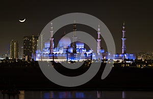 Sheik Zayed Mosque as seen at night with moon