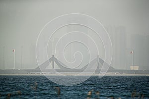 Sheikh Salman Causeway bridge and Bahrain skyline during duststorm