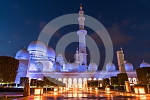 Sheikh Zayed Grand Mosque Centre Abu Dhabi illuminated at night with blue color. The white terraces.