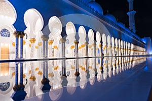 Sheikh Zayed Grand Mosque Centre Abu Dhabi illuminated at night with blue color. The white terraces.