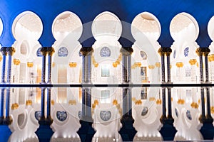 Sheikh Zayed Grand Mosque Centre Abu Dhabi illuminated at night with blue color. The white terraces.