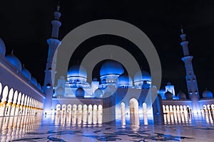 Sheikh Zayed Grand Mosque Centre Abu Dhabi illuminated at night with blue color. The white terraces.