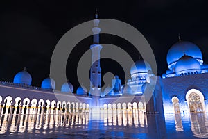 Sheikh Zayed Grand Mosque Centre Abu Dhabi illuminated at night with blue color. The white terraces.