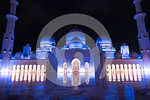 Sheikh Zayed Grand Mosque Centre Abu Dhabi illuminated at night with blue color. The white terraces.