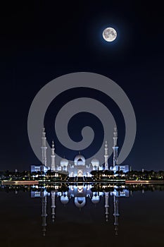Sheikh Zayed Grand Mosque illuminated at full moon night