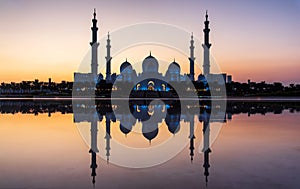 Sheikh Zayed Grand Mosque reflected on the water in Abu Dhabi emirate of UAE