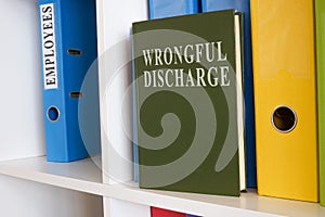 Shelf with book about wrongful discharge.