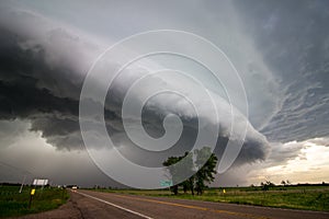 A shelf cloud approaches over a highway in the plains before a derecho. photo