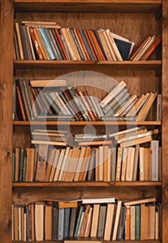 Shelf Filled With Old Books, Vintage Charm And Nostalgic Appeal Of Aged Literature. Weathered Book Spines And Aged Pages