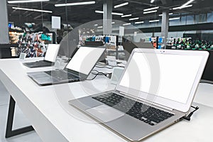 Shelf with laptops in the technology store. Choosing and buying a laptop in the electronics store. Computer shop