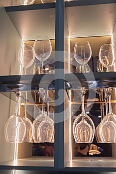 Shelf with many empty glasses in evening light