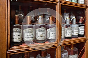 Shelf with medicines in glass bottles in a vintage pharmacy